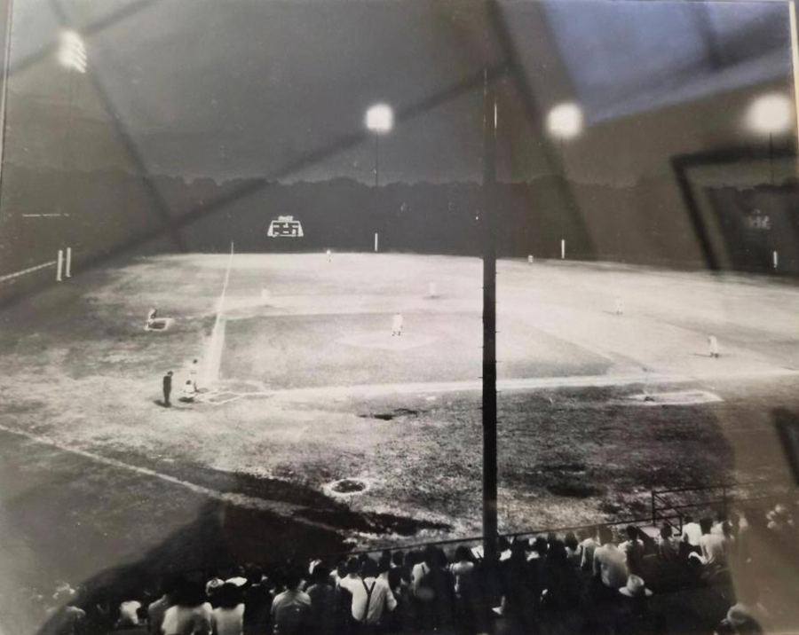 A night baseball game under the lights at Holman Stadium