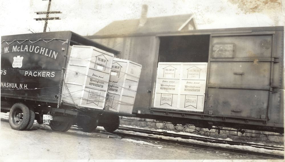 Westinghouse refrigerator crates being transferred from a rail car in Nashua